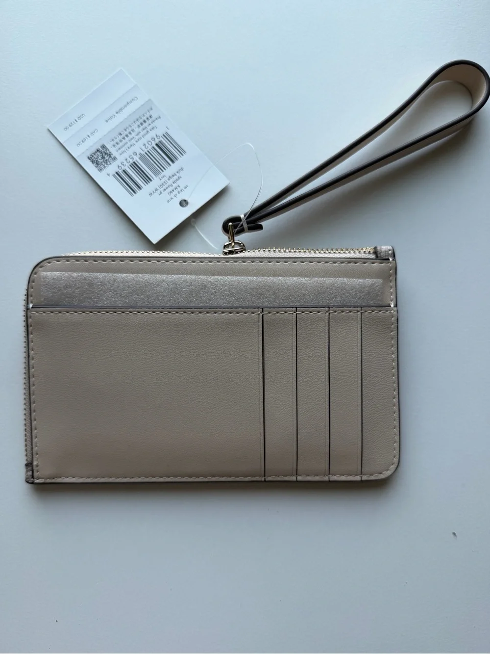 kate spade beige patterned wristlet card case with gold logo